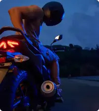 Rear view of the TVS Raider 125 2025 showing LED tail lamp, sleek grab rails, and stylish exhaust design.