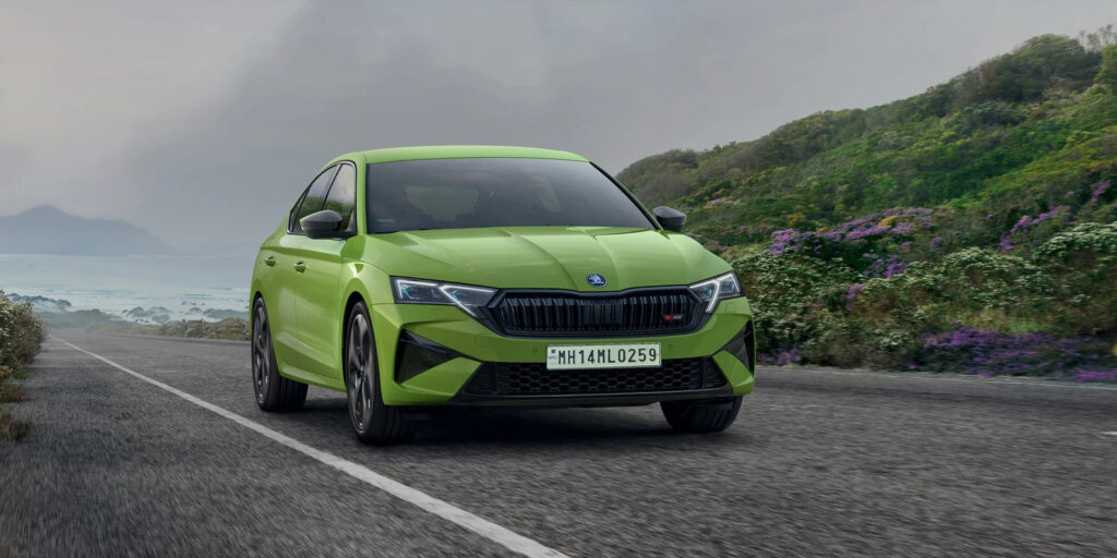 Skoda Octavia RS 2025 driving on a scenic road in India, showcasing sporty design and dynamic stance